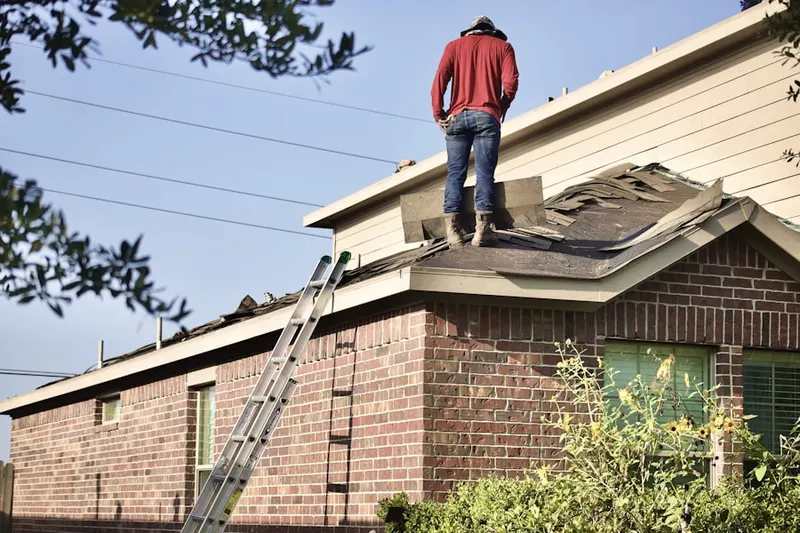 Professional roofer working on a residential roof in Texas Christian University
